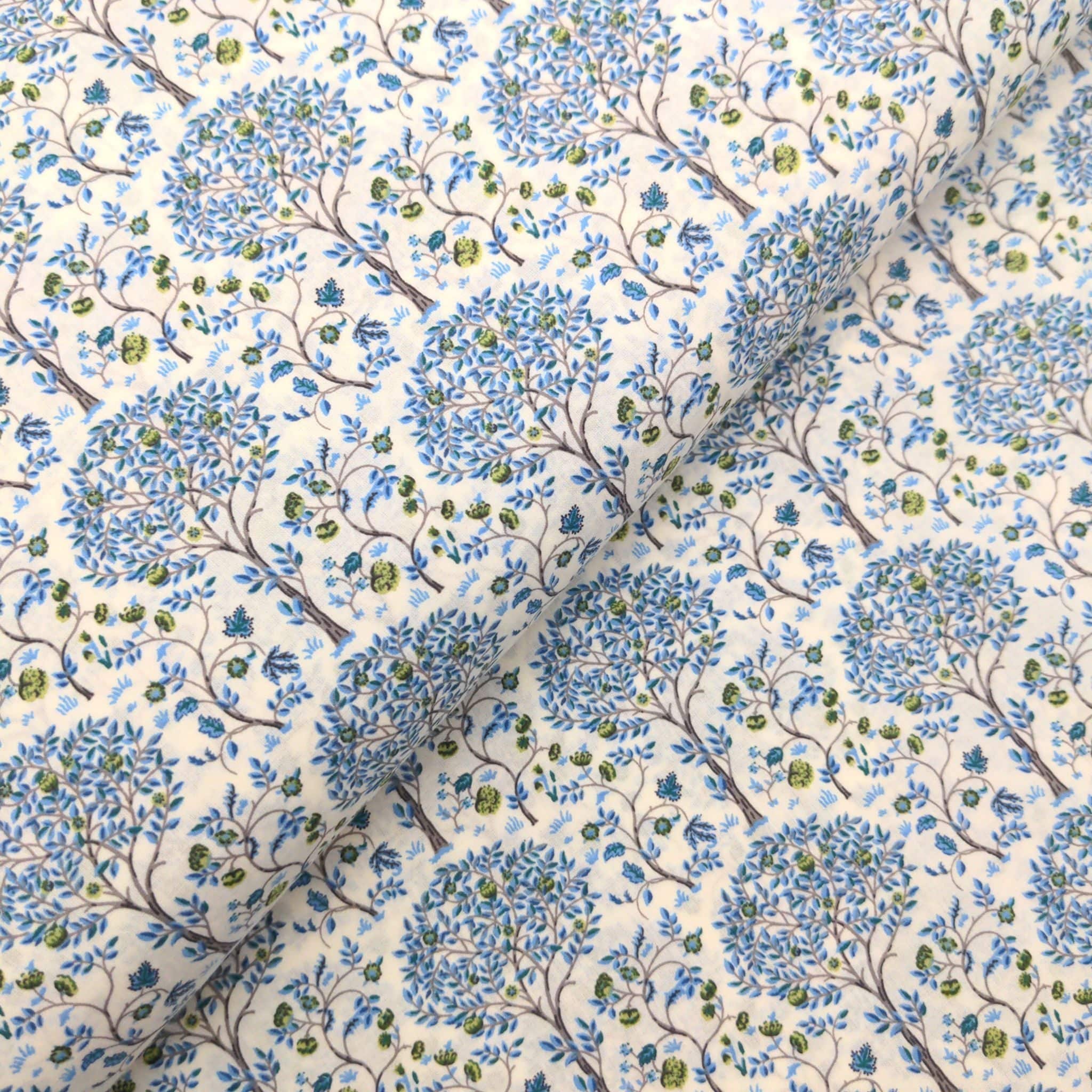 blue trees on a cream cotton lawn fabric - Pima