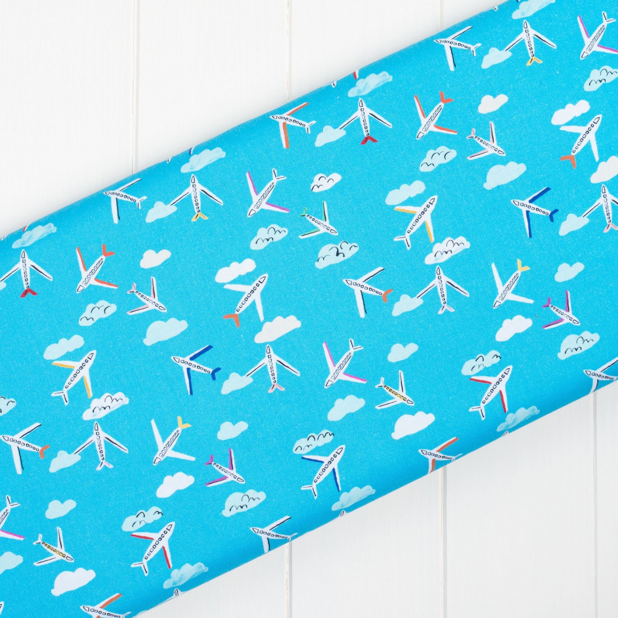 bright blue fabric with aeroplanes and clouds - Lazy Days by Dashwood Studio