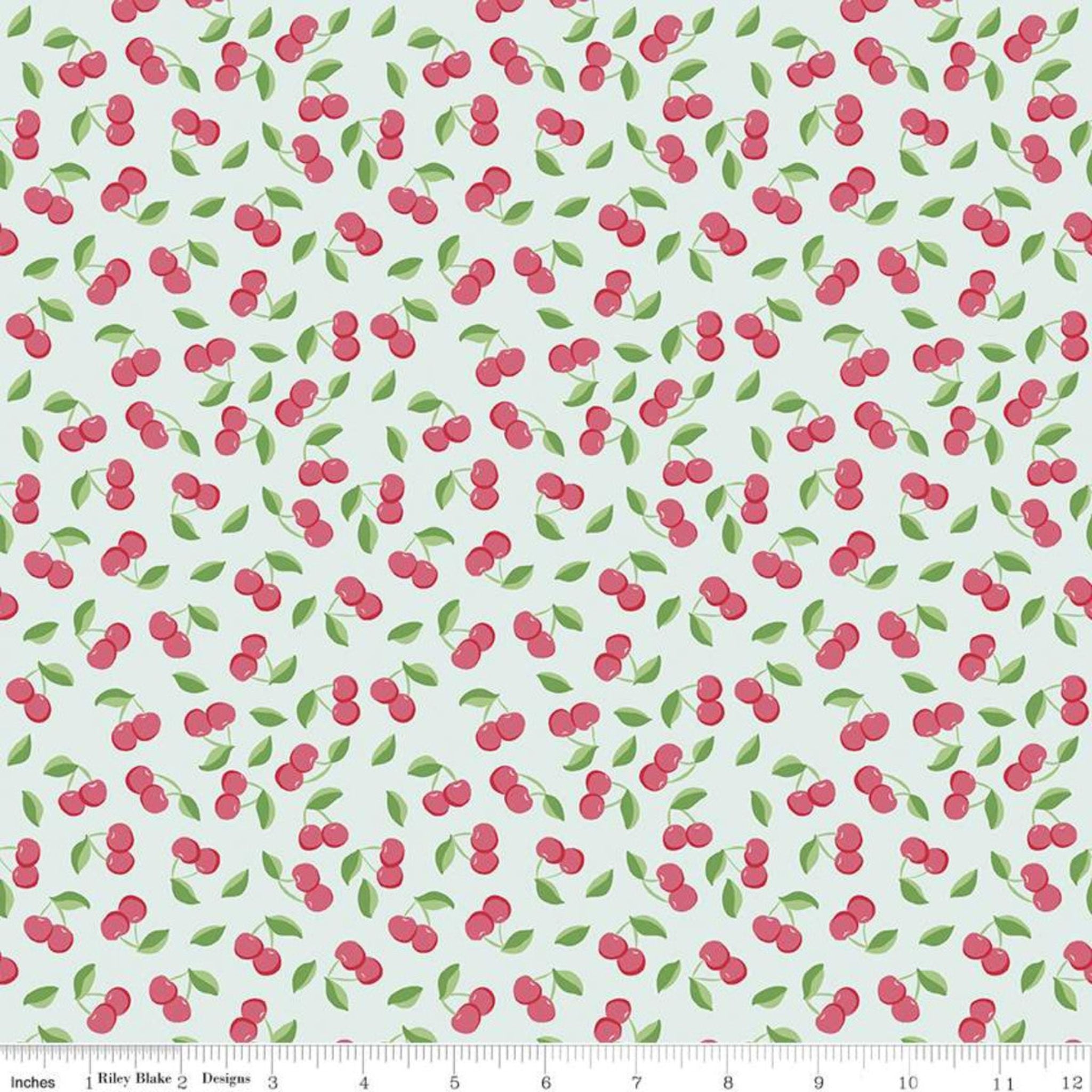 Red cherries on green cotton fabric - Riley Blake