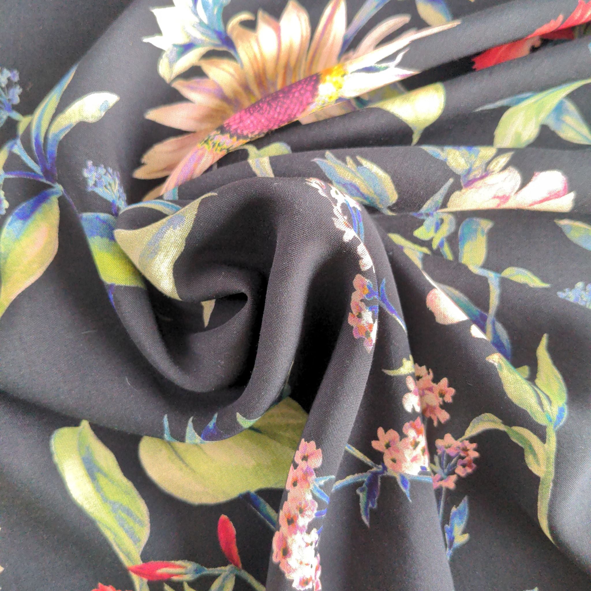 Large colourful florals on black viscose dressmaking fabric