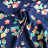 Bright florals in green and orange on navy ananda viscose fabric