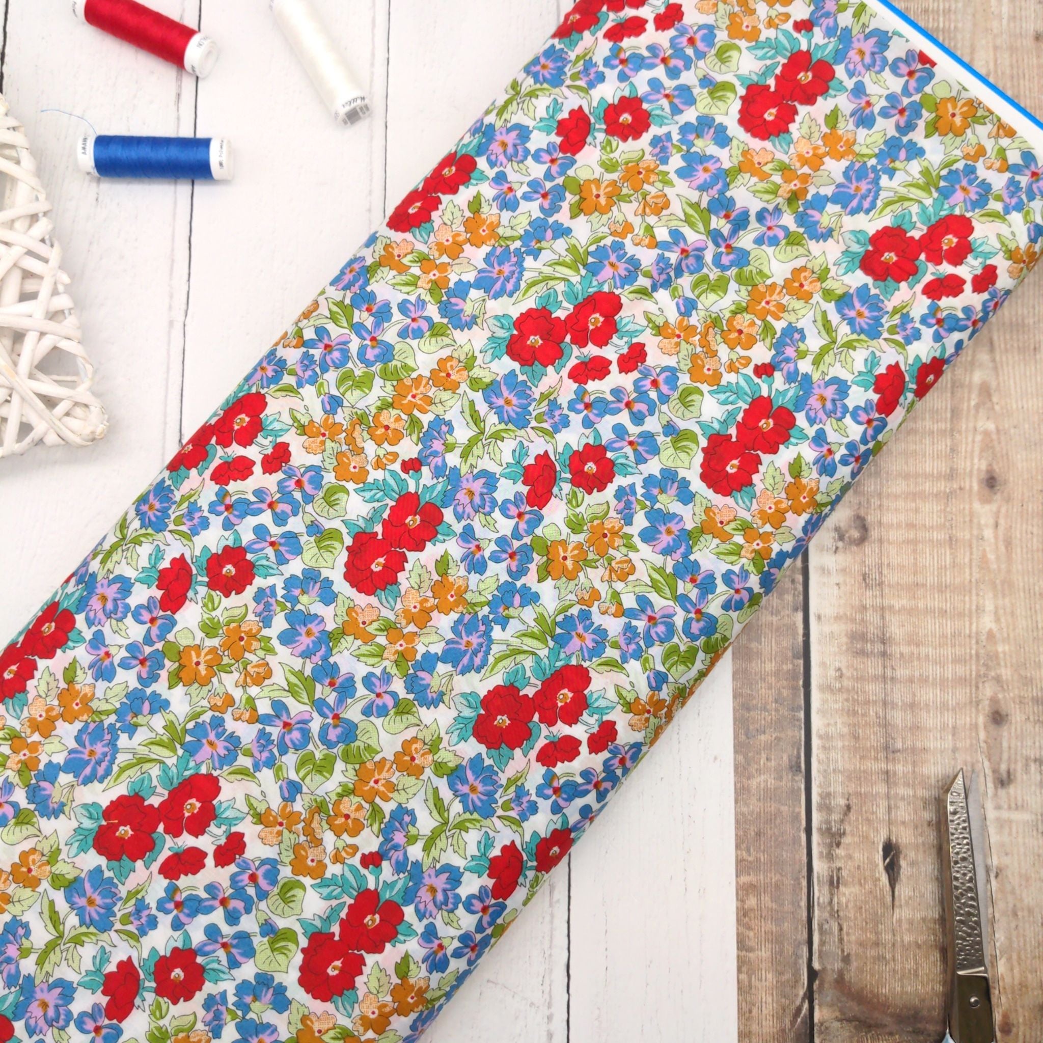 Cotton lawn dressmaking fabric with red and blue flowers - Peter Horton