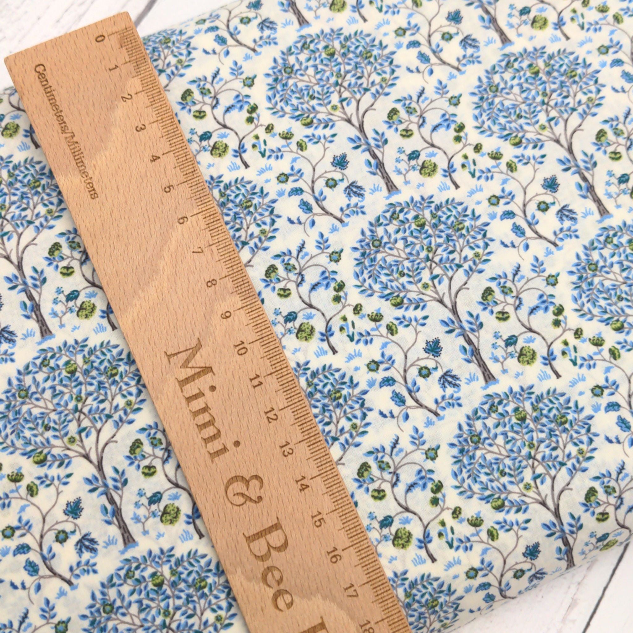 Pima cotton lawn with blue trees on cream