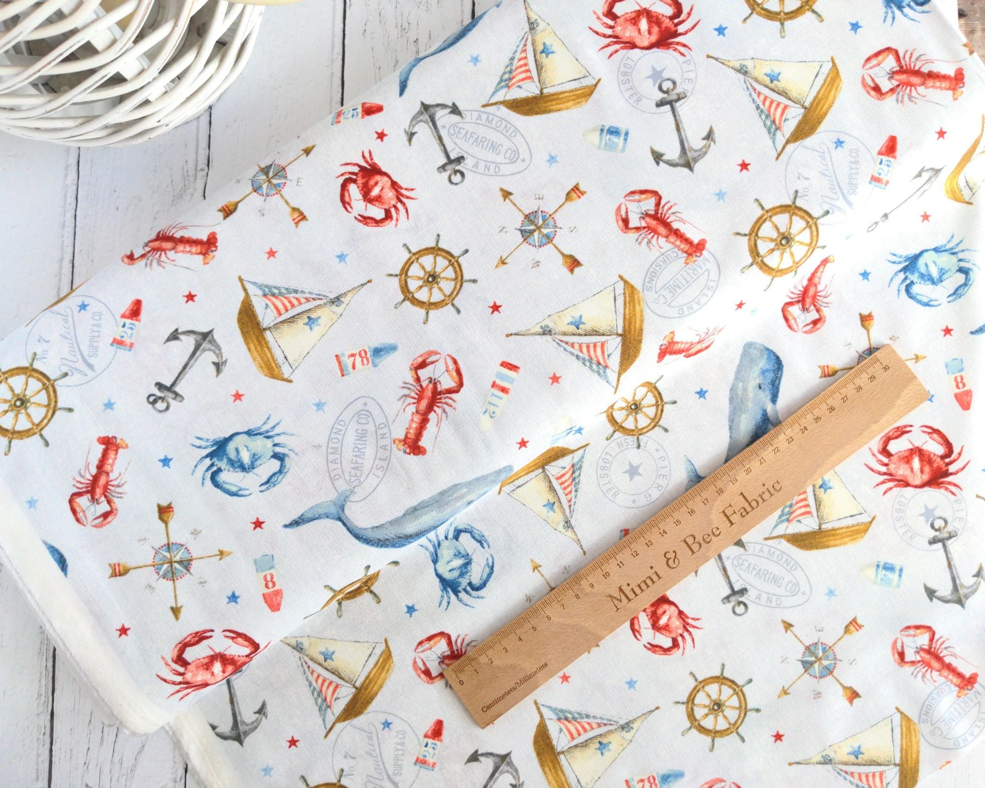 Ship wheel, crabs, whales and ships on a pale grey cotton fabric - At the Helm by Wilmington