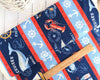 Seaside fabric with lobster, wales and text on a wide striped cotton fabric - At the Helm - Wilmington 