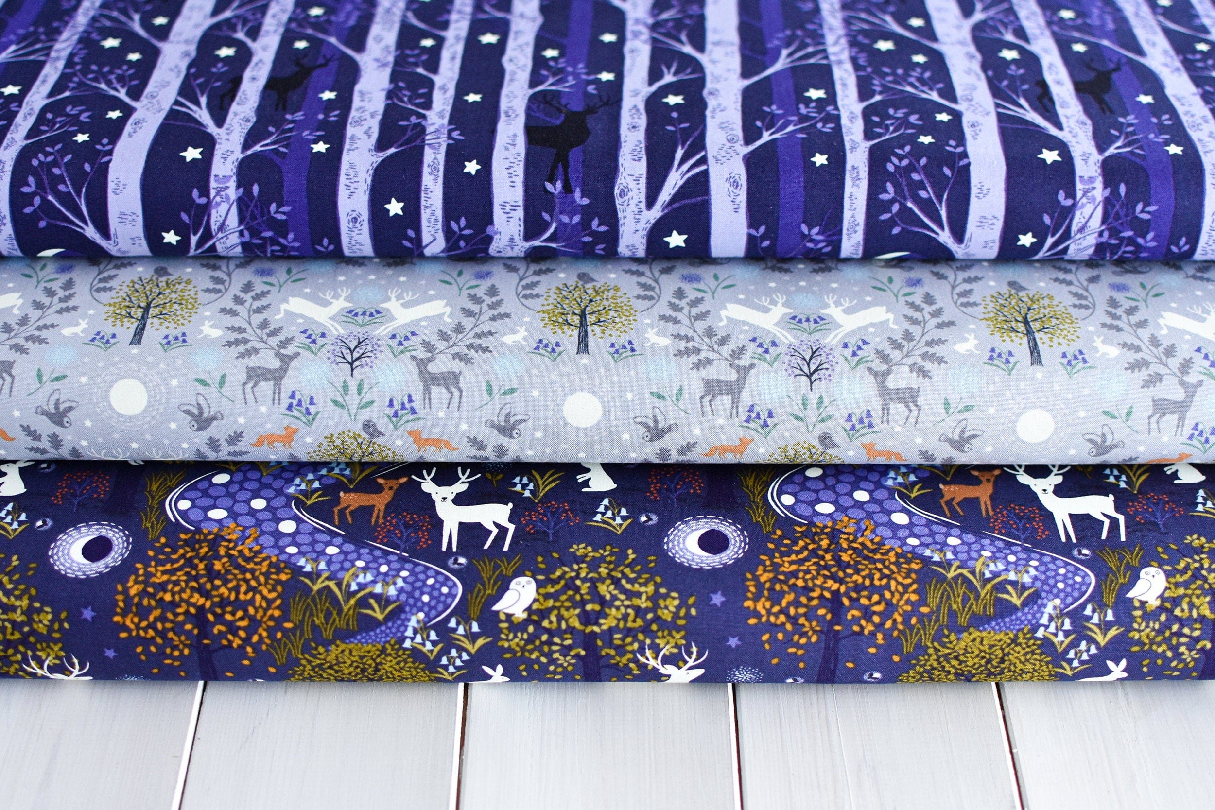 Fabric Glow fireflies on dark cotton fabric - 'Bluebell Wood' Lewis & Irene