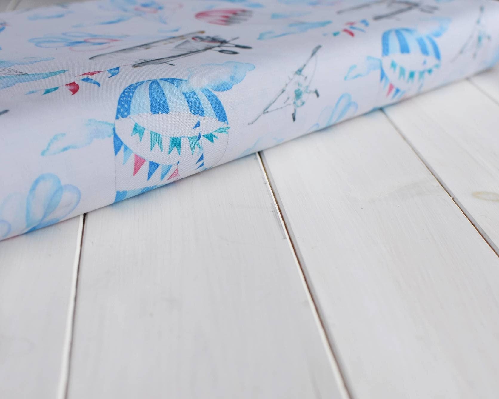 Air balloon and plane on white cotton fabric