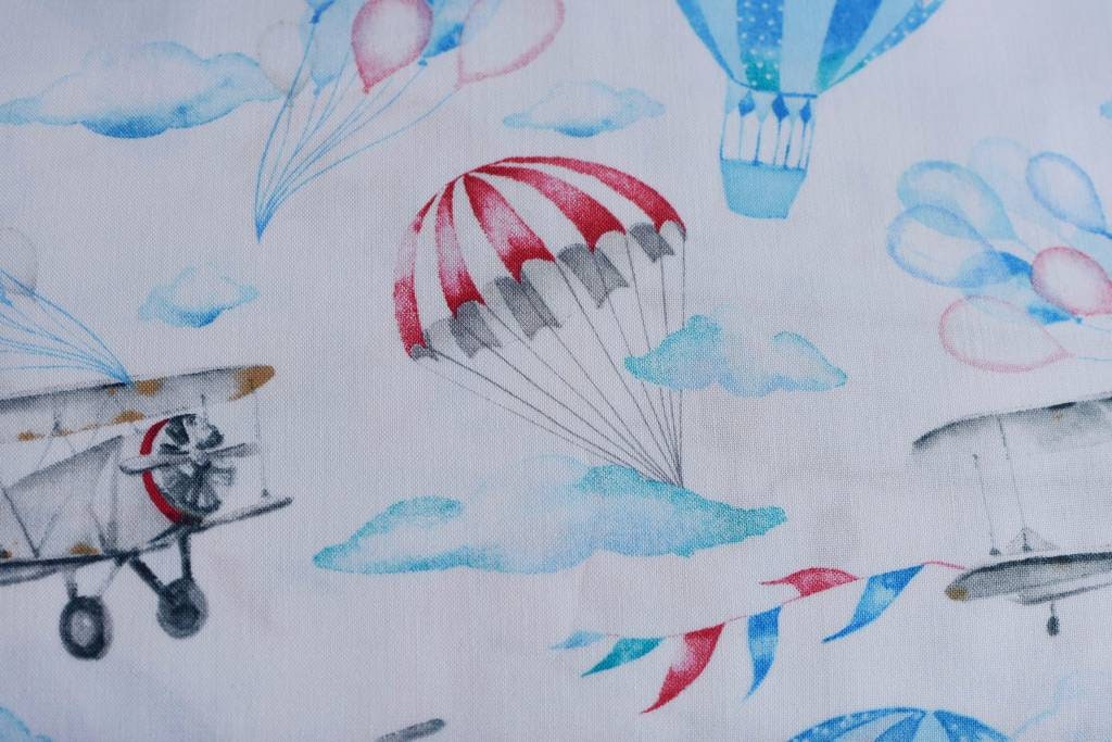 Air balloon and plane on white cotton fabric