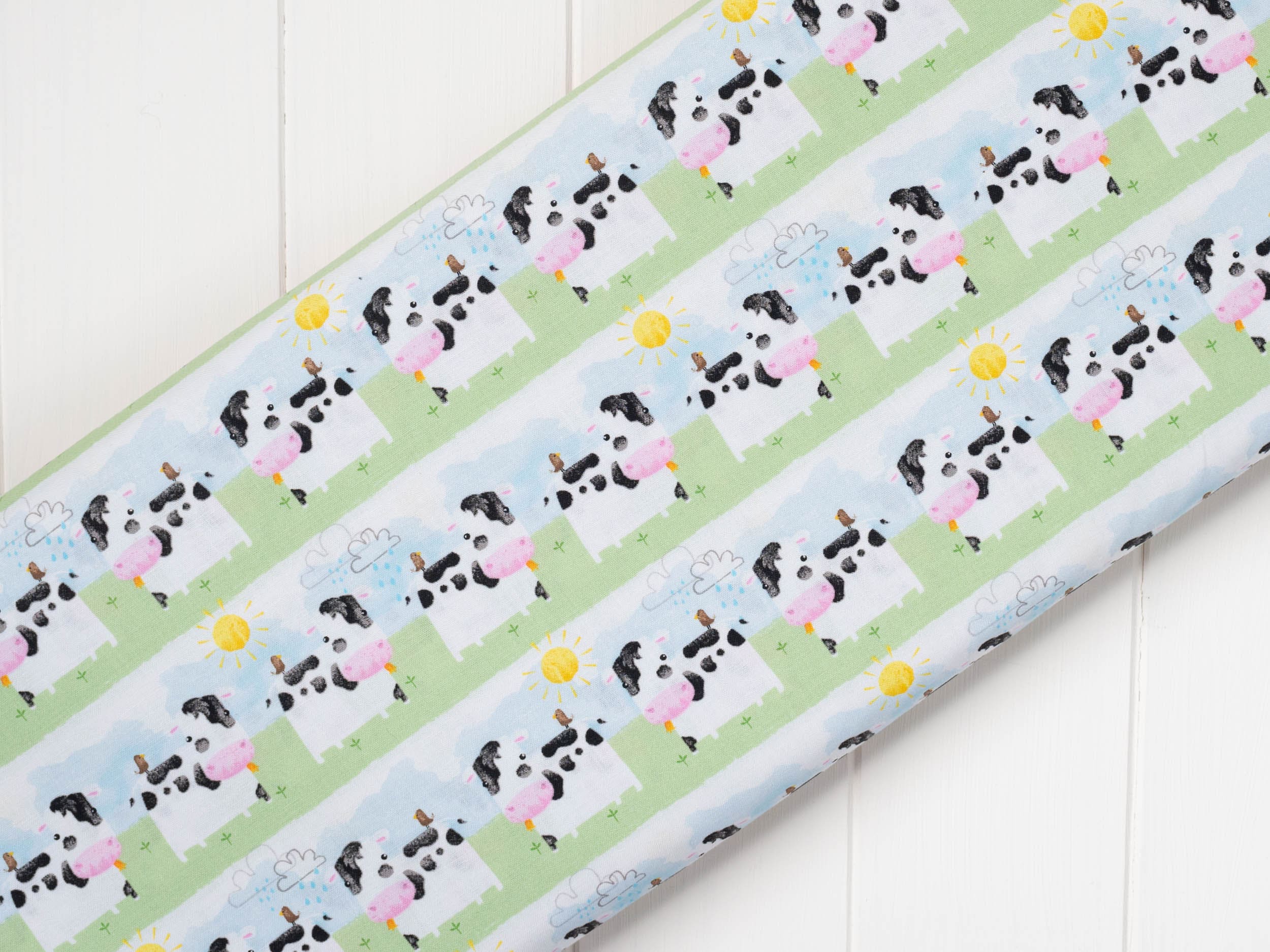 Striped fabric with cows all in a line with sun shining - Playful Farm by Fabric Editions