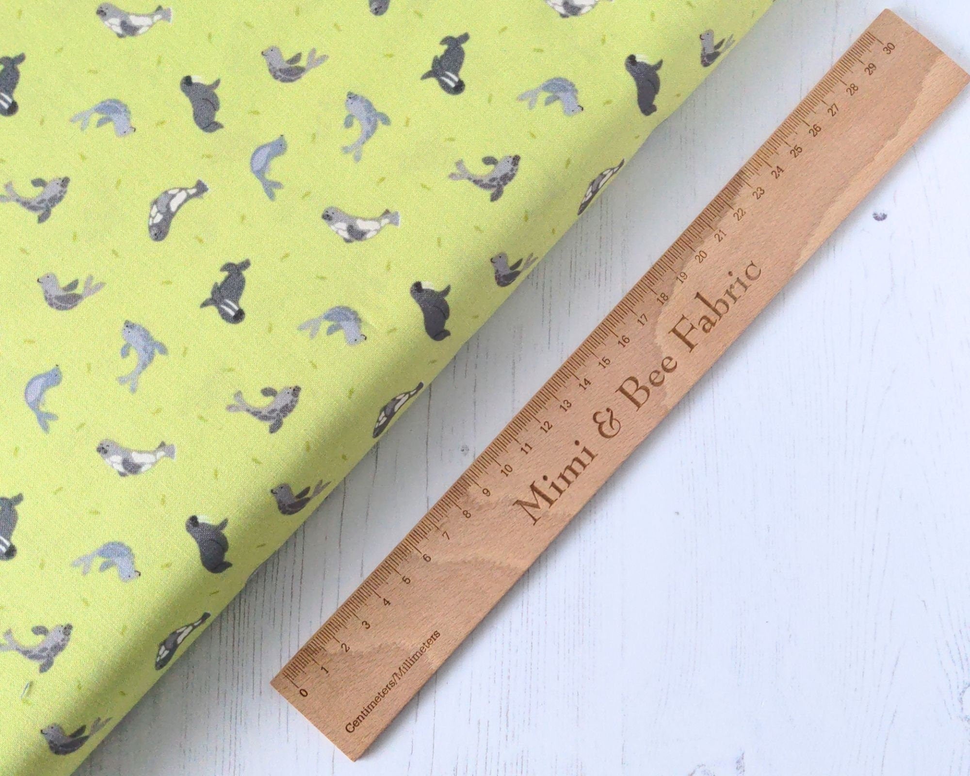 Grey Seals on lime green cotton fabric - Polar Animals by Lewis & Irene