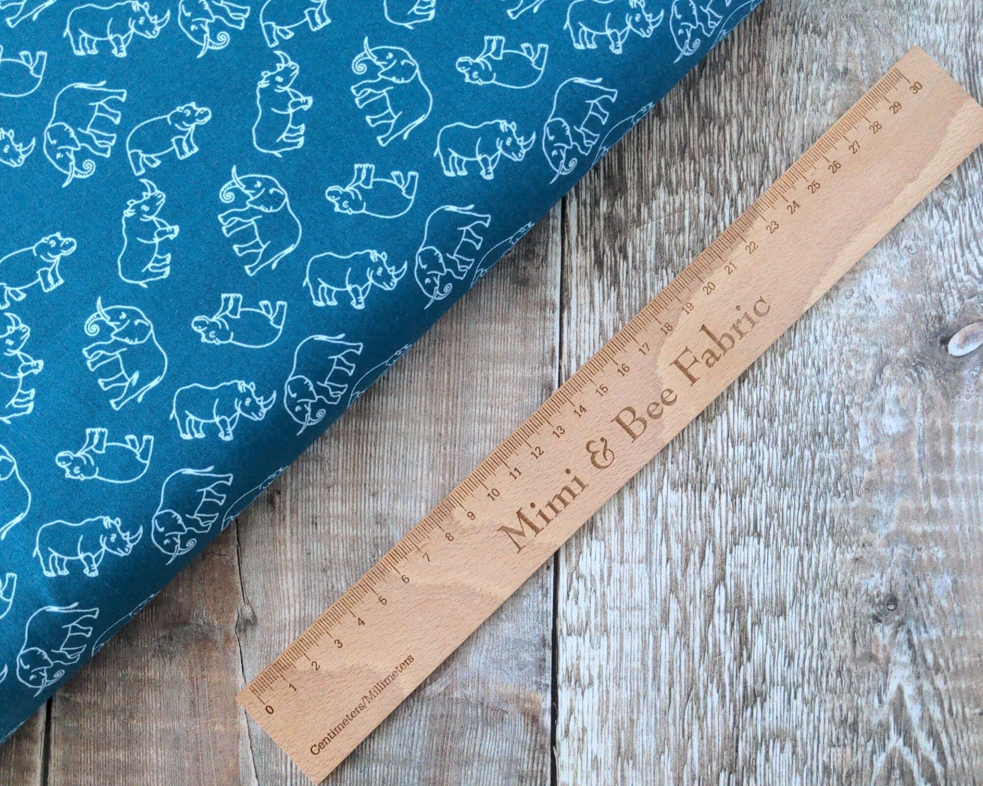 Elephants, rhinos and hippos on petrol blue cotton fabric