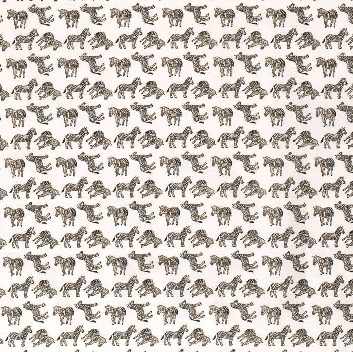 Zebras on white cotton fabric