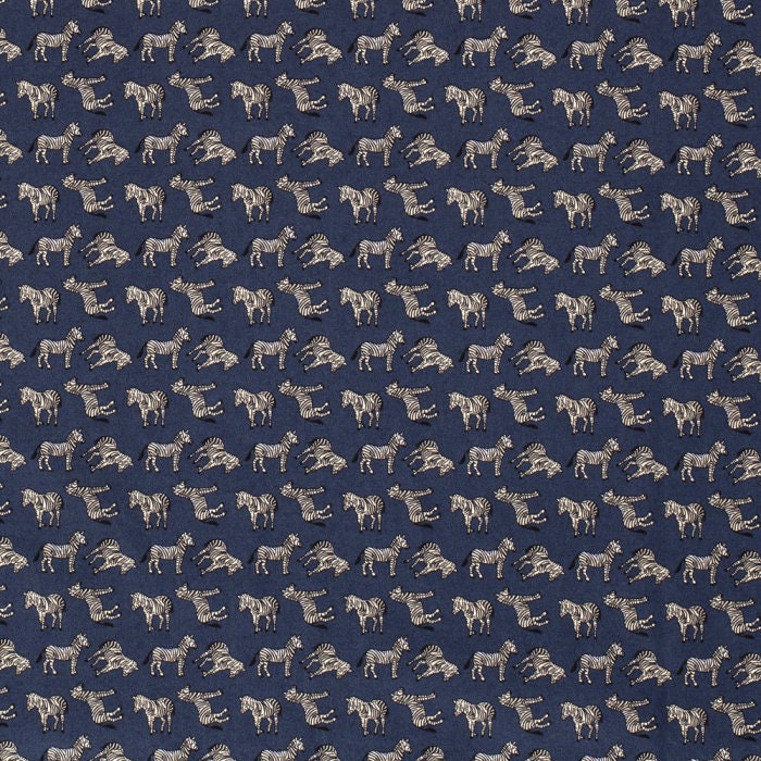 Zebras on dark blue cotton fabric