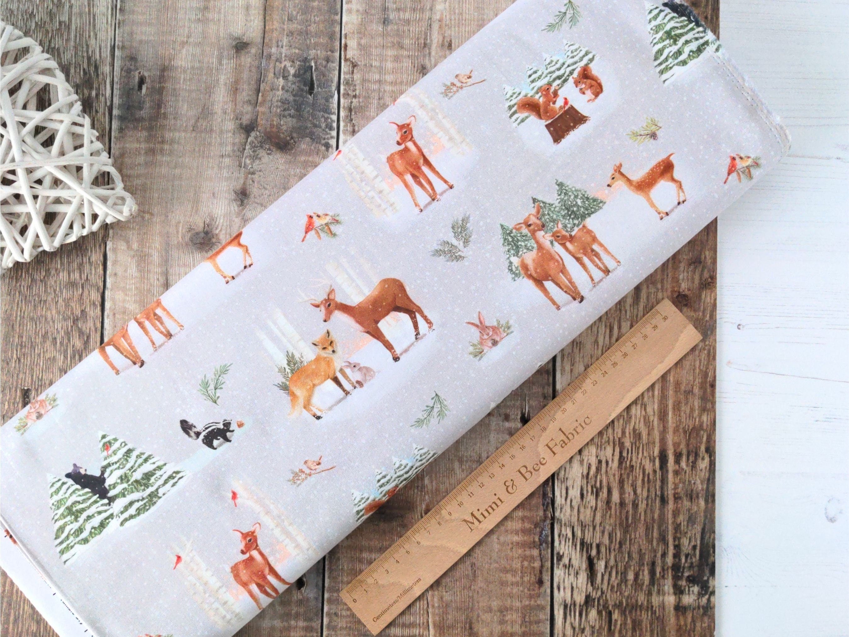 Black bears, skunks, foxes, rabbits, squirrels and deer in the snowy forest on light grey cotton