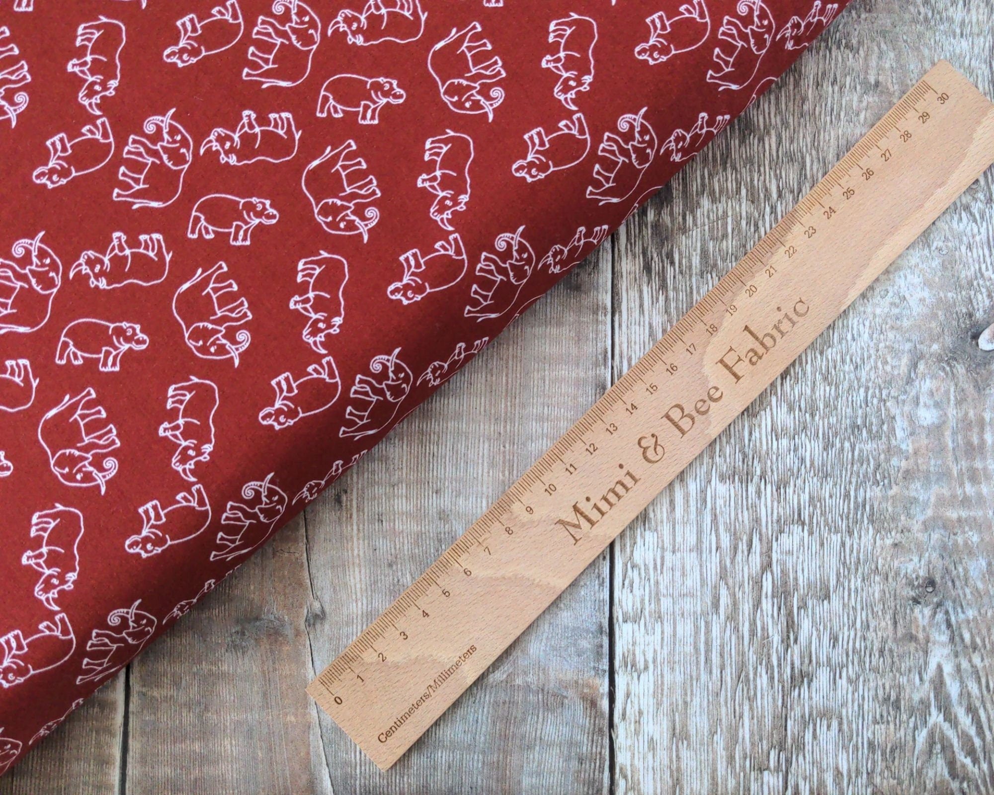 Elephants, rhinos and hippos on rust wide cotton fabric
