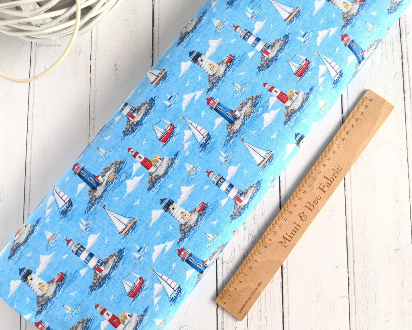 Fabric Lighthouses Clouds on light blue cotton fabric- Nautical by Makower