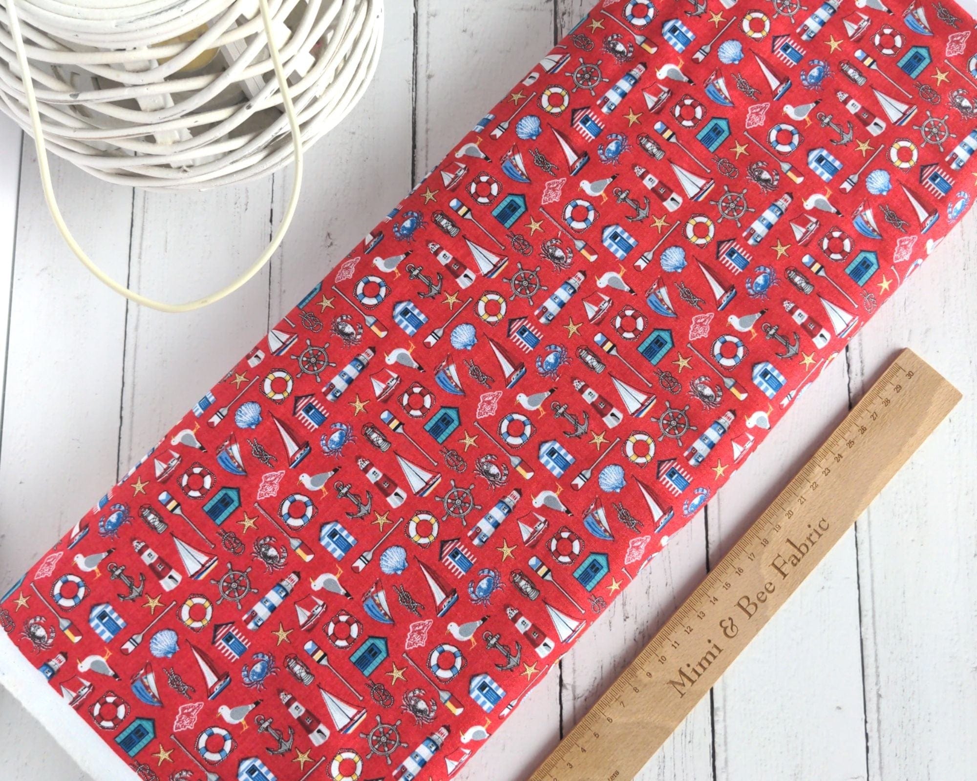 Fabric Seaside beach huts and lighthouses on red cotton fabric- Nautical by Makower