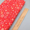 Fabric Snowflakes on red cotton fabric - Makower