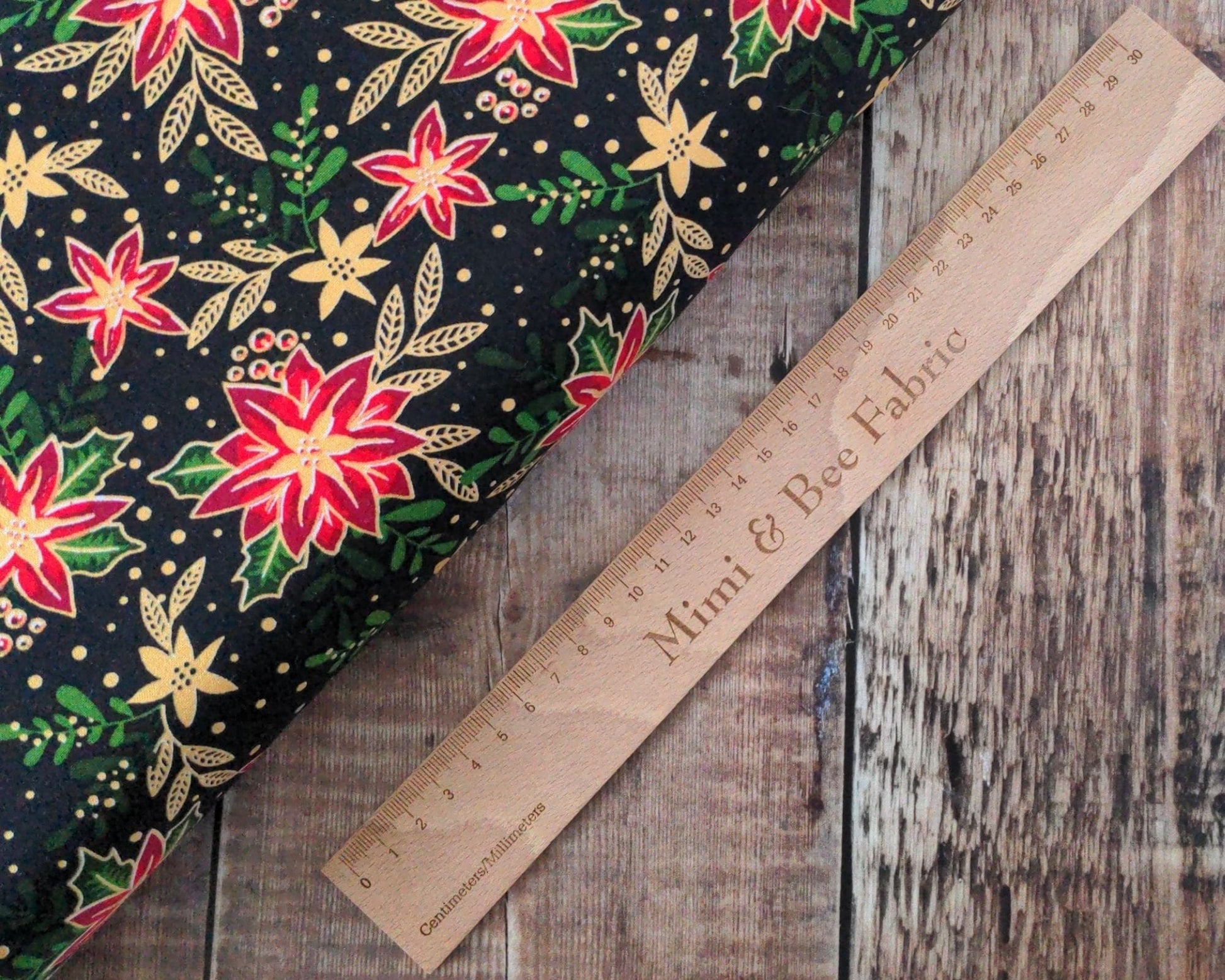 Fabric Winter floral holly and poinsettia with metallic gold on black 100% cotton - 2806-01 CraftCottonCo